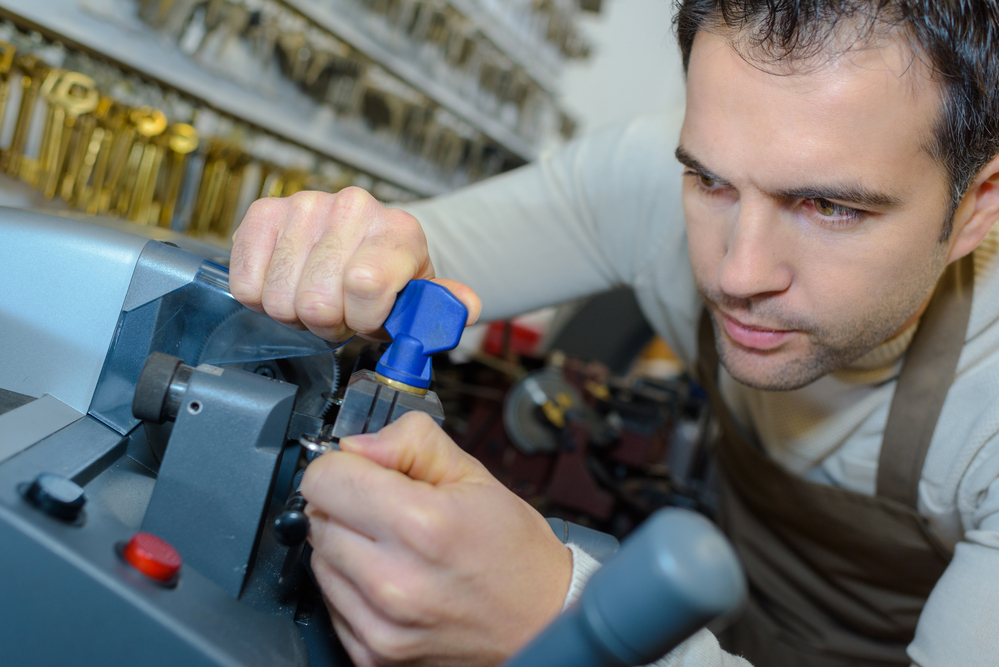 Mobile locksmith cutting a new key